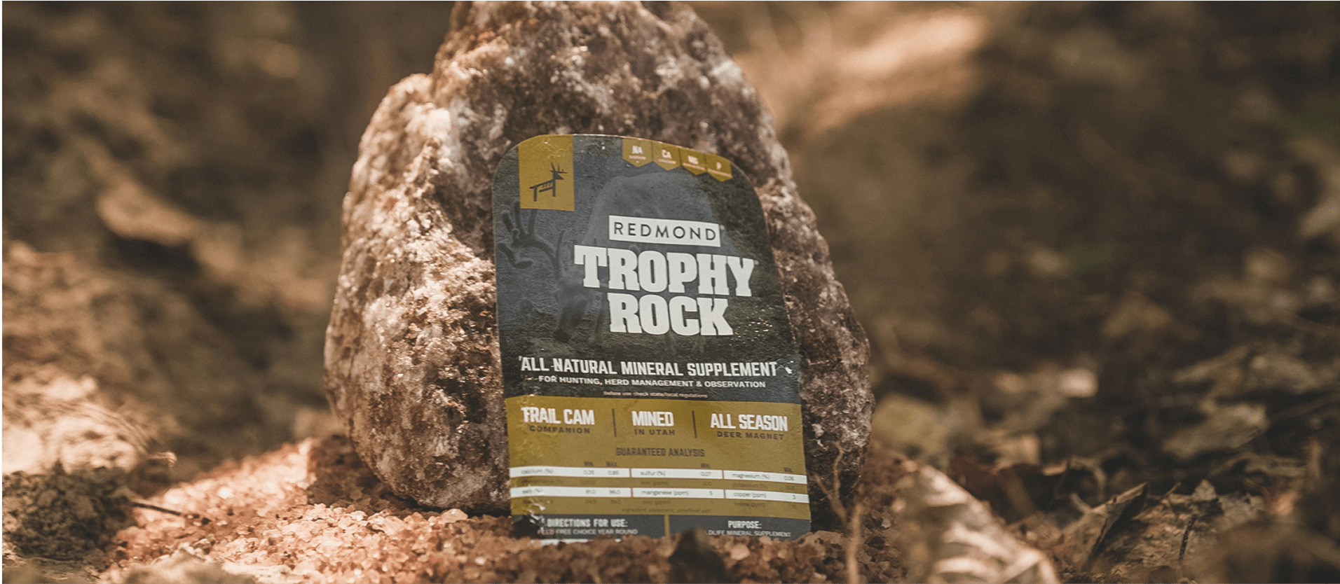 A wrapped Trophy Rock--the #1 selling deer mineral--being placed on the ground.